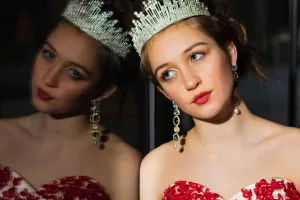 Photo of model Freya Callaghan dressed in a red gown and wearing a beautiful sparkly tiara.