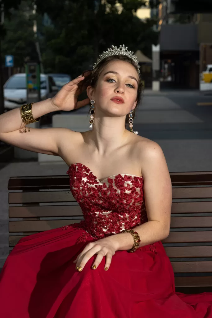 Photo of model Freya dressed in a red gown and wearing a beautiful sparkly tiara.